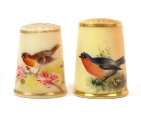 Two 19th Century Royal Worcester puce ground porcelain thimbles, unmarked, each painted with a red breasted bird amid flowers