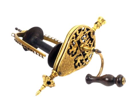 The mechanism from an 18th Century girdle spinning wheel, probably French, the gilt brass girdle form tear drop frame engrave