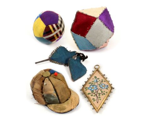 Six pin cushions and cards, comprising a minutely stitched patch work ball, 3.5cms, a patch work geometric example with part 