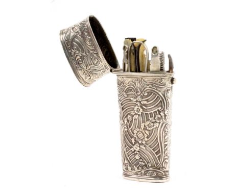 A late 18th Century silver cased travelling etui, unmarked, of oval section and tapering form, the case decorated with flower