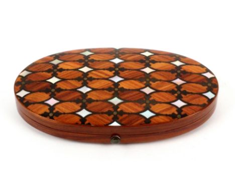 An attractive French etui, circa 1850, the oval tulip wood case with mother of pearl, rosewood, and brass dot decoration, the