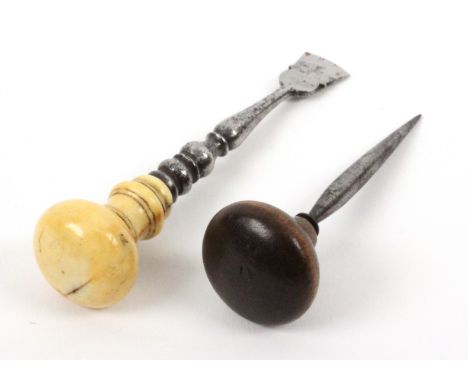 A seam knife or button hole cutter and a stiletto, the first with thistle shaped blade and steel stem to a turned bone handle