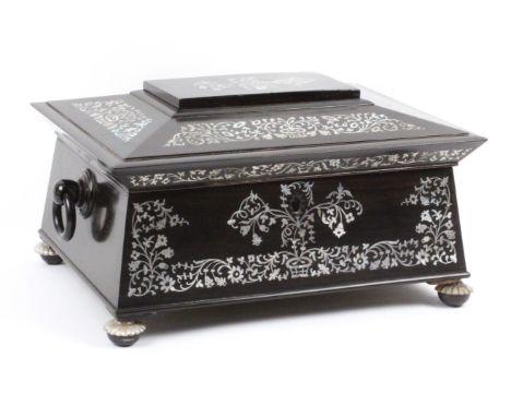 An elaborate ebony and cut mother of pearl inlaid sewing box, circa 1860, of sarcophagol form, the lid and front with panels 