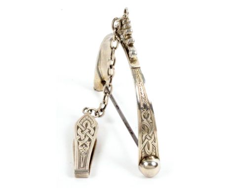 A nice example of an English silver spool knave, the leaf engraved clip with a chain to a 'C' scroll mount, the stirrup frame