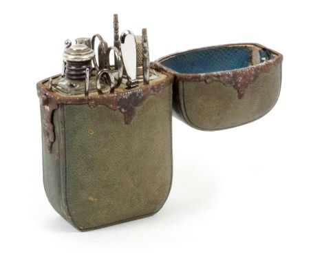 A French sewing companion, circa 1870, of curved rectangular form covered in green leather with fancy steel hinge mount and c