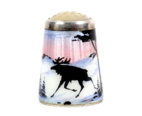 A Norwegian silver gilt and enamel moonstone top thimble by Aksel Holmsen, depicting a moose at pace in a wooded snowy landsc
