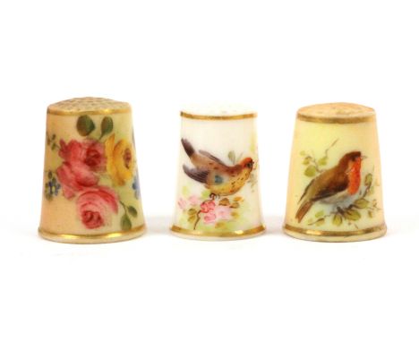 Three English Royal Worcester porcelain thimbles, comprising two 19th Century puce ground examples, unmarked, one painted wit