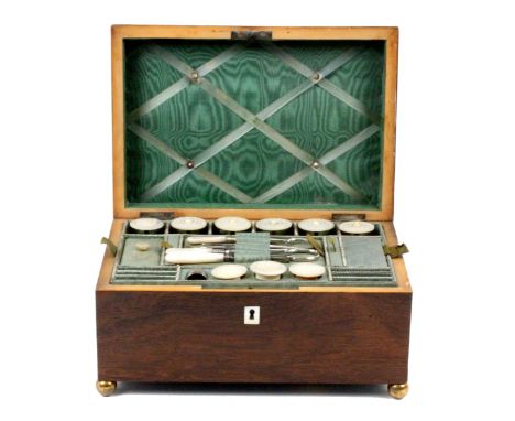 A well fitted French rosewood sewing box, circa 1840, of rectangular form, the lid with box wood line edge and inlaid spandri