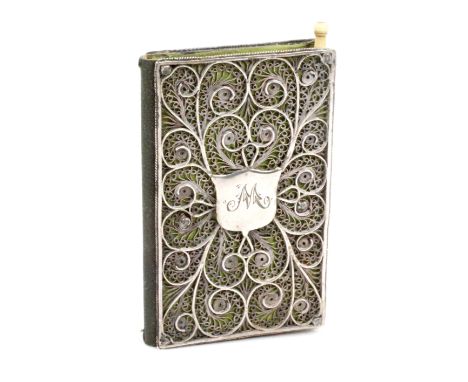 A late 18th Century silver filigree needle book, the covers in elaborate scrolling quill work the front cover with a central 