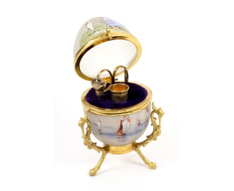 A French or Dutch sewing etui, circa 1890, the gilt brass tripod base cast with mythical bird heads supporting a glass egg pa
