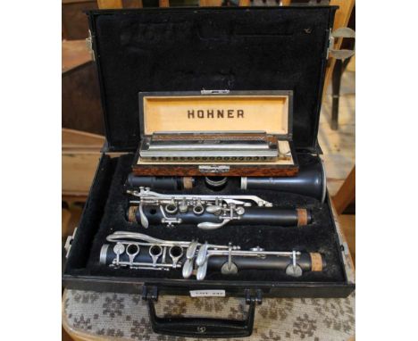 A CASED CLARINET together with a cased Hohner chromatic harmonica 