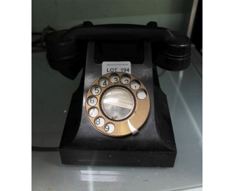 A VINTAGE BLACK FINISHED DIAL TELEPHONE with modern wiring 