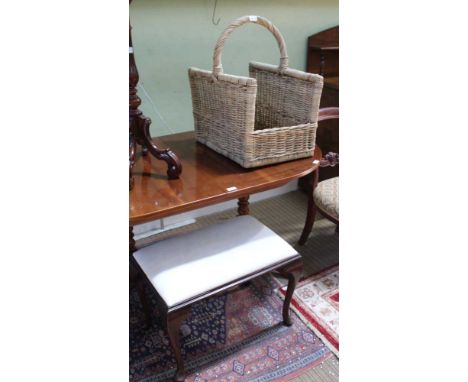 A WOVEN WICKERWORK LOG CADDY sold together with a pad topped four legged stool 