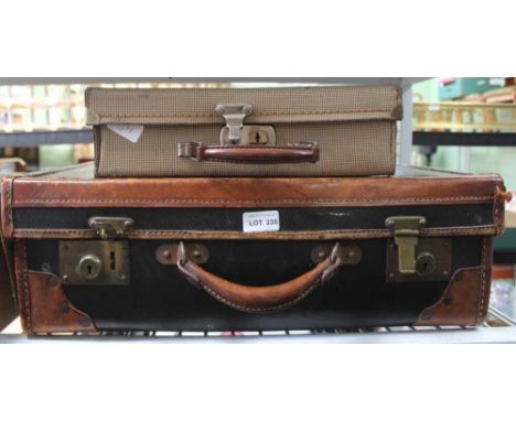 A VINTAGE LEATHER BOUND SUITCASE together with a mid-century smaller case 