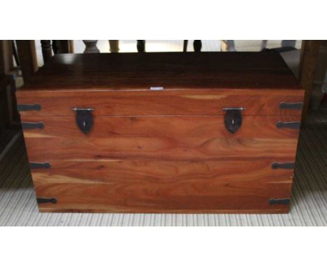 AN ORIENTAL MAHOGANY FINISHED PART METAL BOUND TRAVELLING STYLE TRUNK 