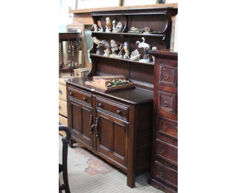 AN ERCOL BRANDED KITCHEN DRESSER with low twin shelf plate rack back, over two inline drawers &amp; two cupboard doors 