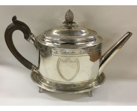 PETER &amp; ANN BATEMAN: A large Georgian silver teapot with bright cut decoration and pineapple finial together with a match