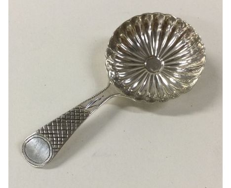 A Georgian silver caddy spoon with fluted bowl. Birmingham. By IT. Approx. 7 grams. Est. £70 - £80.