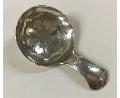 A good Georgian bright cut silver caddy spoon. Birmingham. By IT. Approx. 7 grams. Est. £70 - £80.