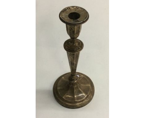 A large panelled silver candlestick on spreading base. London. Approx. 245 grams. Est. £30 - £50.