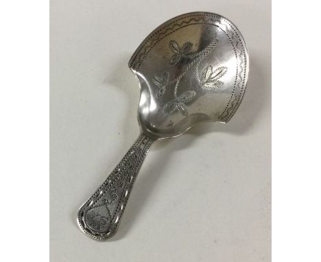 A Georgian bright cut silver caddy spoon with floral decoration. Birmingham. By IT. Approx. 7 grams. Est. £70 - £80.