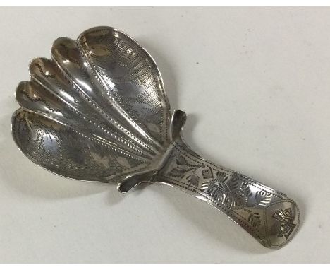 A Georgian silver bright cut decorated caddy spoon. Birmingham. By IB. Approx. 5 grams. Est. £60 - £80.