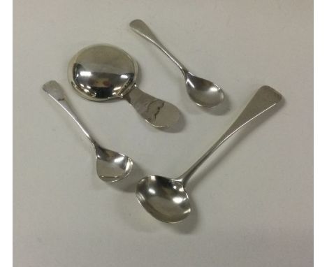 A Georgian silver caddy spoon together with other cruet spoons. Various dates and makers. Approx. 22 grams. Est. £15 - £20.
