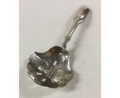 A good large Georgian silver caddy spoon with pierced bowl. Birmingham. By IT. Approx. 13 grams. Est. £70 - £80