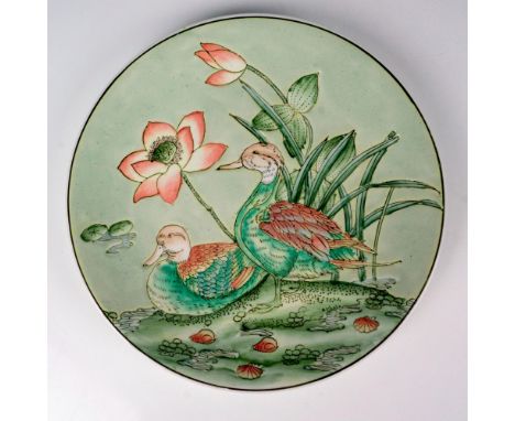 A beautiful pale green enamel plate depicting two ducks resting beside pink lotus blossoms. Da Qing Qianlong Nian Zhi (Great 