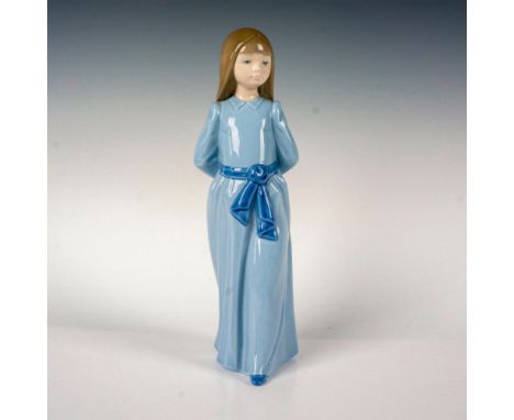 Glossy finish porcelain modeled as a young girl wearing a blue gown. Nao by Lladro backstamp. This item has its original box.
