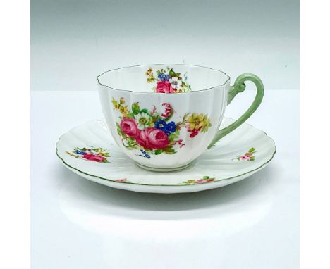A floral ludlow shaped cup and saucer with green trims. Shelley backstamp and 13240 marked on the underside. Cup: 4.25"L x 3.