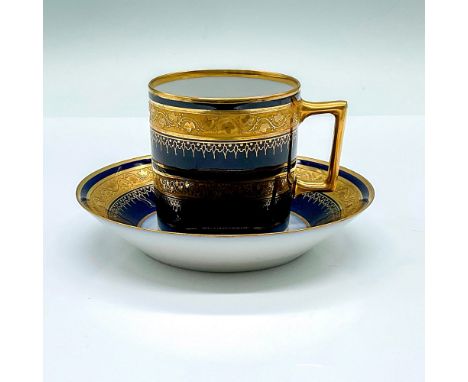 Antique cobalt blue glazed cup and saucer. Adorned with gilded leaf band trim. Sevres backstamp. Cup: 3.25"L x 2.5"W x 2.5"H.