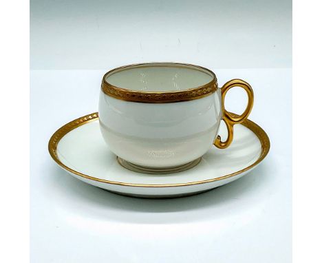 A set of white cup and saucer decorated with a gilded laurel band. Elite Works Limoges France backstamps. Cup: 4"L x 3"W x 2.