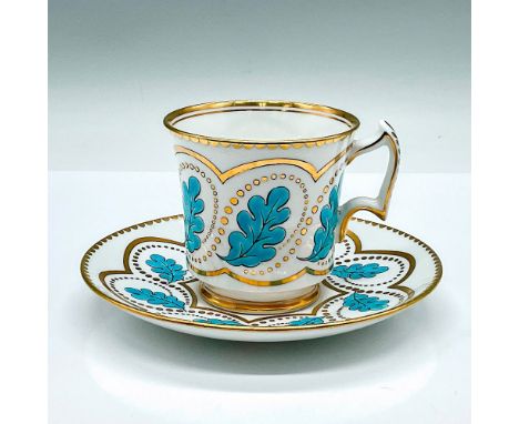 A white cup and saucer set, beautifully decorated in a blue leaf enamel and gilded accented pattern. Royal Chelsea backstamp.