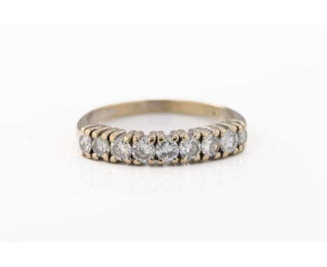 An 18ct white gold diamond half eternity ring, with nine brilliant-cut claw-set diamonds, ring size R, estimated total diamon