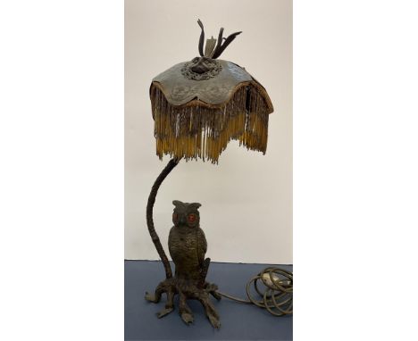 An Austrian bronze owl table lamp and shade, the owl with orange glass eyes, the cast bronze shade with three owl faces again