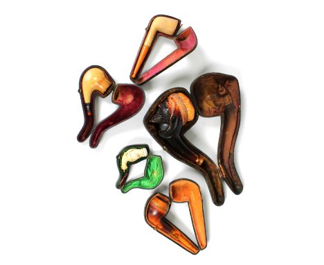 A small collection of cased used pipes, to include a 19th century Meerschaum pipe, in the form of a bearded gentleman wearing