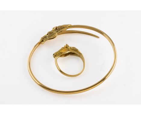 An 18ct yellow gold bangle, terminating with a horse head, London import marks for 1980, total gross weight approximately 7.4