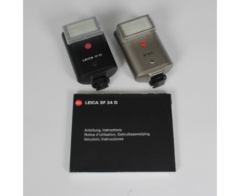 Leica SF 24 D Titanium Flash Unit with booklet and soft pouch, together with A SF 20 flash unit. (2)