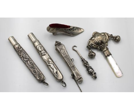 A small collection of Continental 925 Sterling silver collectables, to include a ladies shoe pin cushion; three needle cases;