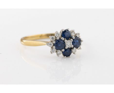 An 18ct yellow gold sapphire and diamond ring, set with four round-cut sapphires, accentuated with brilliant-cut diamonds, ri