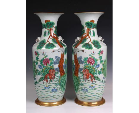 A pair of late 19th or early 20th century Chinese porcelain baluster vases, with long necks and everted rims, polychrome deco