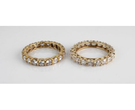 An 18k yellow gold and cubic zirconia eternity ring, size R, total gross weight approximately 4g; together with another simil