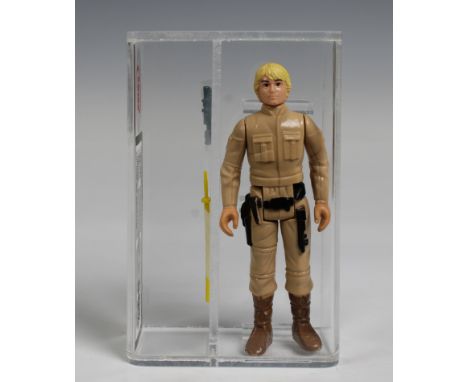 A loose, graded vintage Star Wars Luke Skywalker 'Besbin' with original blaster and lightsaber., Cased in acrylic and graded 