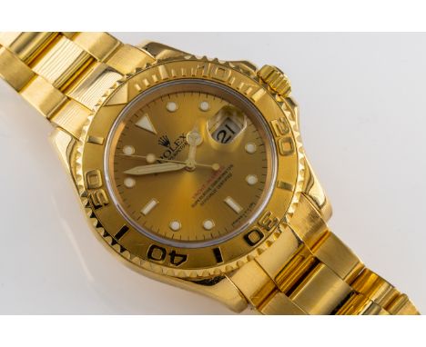 Rolex - An 18k yellow gold Oyster Perpetual Date Yacht-Master, model 16628, number T905856, 30mm champagne dial, with illumin
