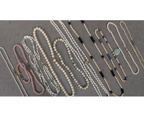 A group of pearl necklaces, including a freshwater pearl two row necklace, on a 14k yellow gold clasp; together with a cultur