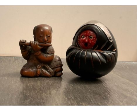 A Japanese Kobe (Kobi) wooden hand carved Doll with red face and moveable protruding eyes and tongue, having applied silver m