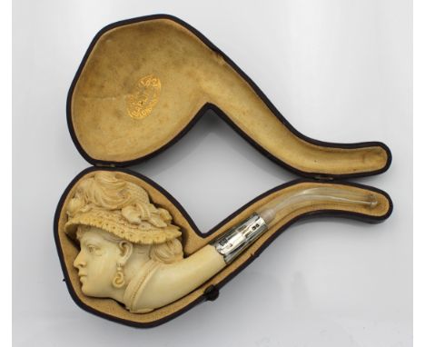 A cased unused Edwardian Barling meerschaum pipe fashioned as a ladies head, wearing a straw bonnet, with silver collar, Edwi