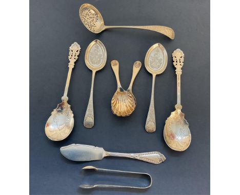 A pair of silver scallop shell caddy spoons, Birmingham, 9.5cm. long, together with a sugar sifting spoon, London, maker's ma