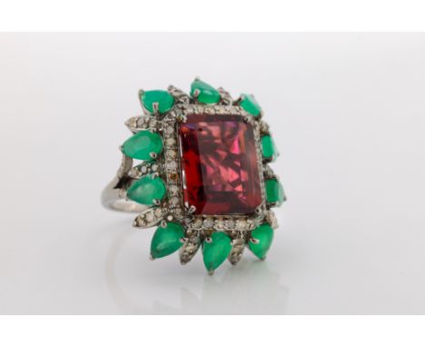 An unusual cocktail ring, set with a large step-cut tourmaline approximately 8.47cts, within a border of diamonds approximate